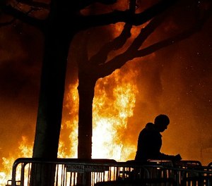 In this Feb. 1, 2017 file photo, a fire set by demonstrators protesting a scheduled speaking appearance by Breitbart News editor Milo Yiannopoulos burns on Sproul Plaza on the University of California, Berkeley campus.