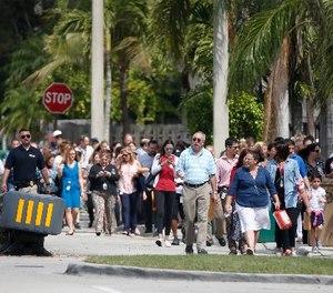People evacuated because of a bomb threat return to the David Posnack Jewish Community Center and David Posnack Jewish Day School, Monday, Feb. 27, 2017, in Davie, Fla. (AP Photo/Wilfredo Lee)