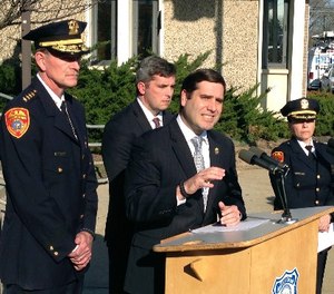 Suffolk County Police Commissioner Timothy Sini, center, addresses the media outside Police Headquarters in Bay Shore, N.Y., Friday, April 14, 2017. (AP Photo/Frank Eltman)