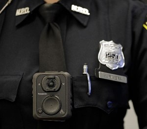 Newark Police officer Veronica Rivera wears a body camera during a news conference at the Panasonic headquarters unveiling body cameras for officers, Wednesday, April 26, 2017, in Newark, N.J. (AP Photo/Julio Cortez)