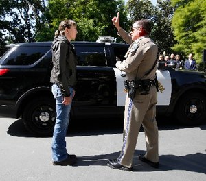 California Highway Patrol Officer Gary Martens, right, has CHP Sgt. Jaimi Kenyon, follow his finger during a demonstration of how drivers, suspected of impaired driving, are currently tested, Wednesday, May 10, 2017, in Sacramento, Calif.