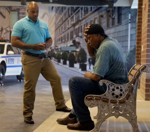 In this Sept. 2, 2015 file photo, New York City Police Officer Lamont Edwards talks to actor Nathan Purdee during a Crisis Intervention Training class at the New York Police Department Police Academy, in New York.