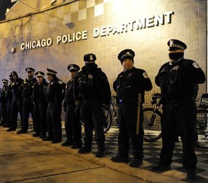 In this Nov. 24, 2015, file photo, Chicago police officers line up outside the District 1 central headquarters in Chicago. (AP Photo/Paul Beaty File)