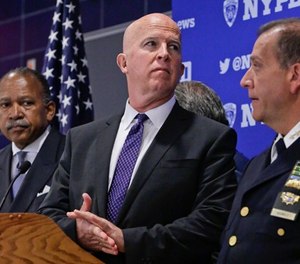 New York Police Department (NYPD) Commissioner James O'Neill, center, Deputy Commissioner Benjamin Tucker, left, and Chief of Department Carlos Gomez, right, prepare for a press conference after a swearing-in ceremony for new police recruits entering the Police Academy, Thursday, July 6, 2017, in New York. (AP Photo/Bebeto Matthews)