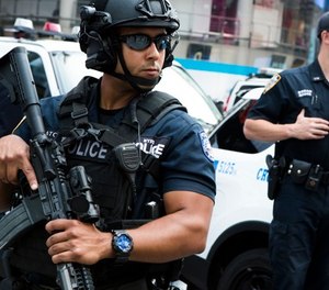 Members of the NYPD Counterterrorism Unit stand guard in Time Square as security is increased as a result of a attack in Barcelona, Spain earlier on Thursday, Aug. 17, 2017, at in New York.
