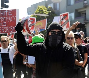 Protesters march outside of Alamo Square Park in San Francisco, Saturday, Aug. 26, 2017.