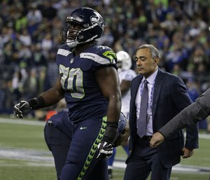 Seattle Seahawks offensive tackle Rees Odhiambo leaves the field with an injury in the second half of an NFL football game. (Photo/AP)