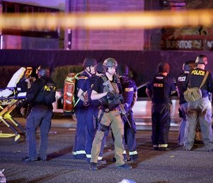 Police officers and medical personnel stand at the scene of the Las Vegas shooting. (AP Photo/John Locher, File)