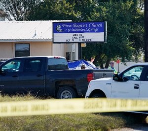 Law enforcement officers work in front of the First Baptist Church of Sutherland Springs after a fatal shooting, Sunday, Nov. 5, 2017, in Sutherland Springs, Texas. (AP Photo/Darren Abate)