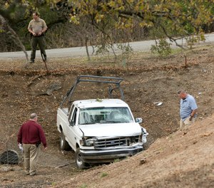 Investigators view a pickup truck involved in a deadly shooting rampage at the Rancho Tehama Reserve, near Corning, Calif., Tuesday, Nov. 14, 2017. A gunman driving stolen vehicles and choosing his targets at random opened fire