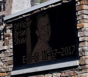 The electronic sign for Mount Saint Peter Church displays an image of New Kensington Police Officer Brian Shaw on Monday, Nov. 20, 2017, in New Kensington, Pa.