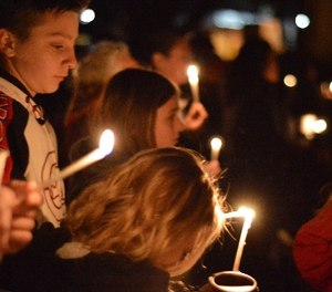 Aztec High School students and area residents gather for a candlelight vigil in Aztec, N.M., Thursday, Dec. 7, 2017, after a shooting at the high school. (AP Photo/Russell Contreras)