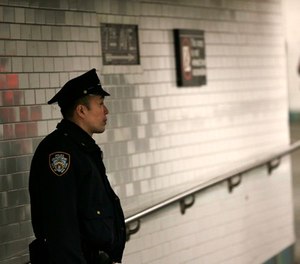 A police officer patrols in the passageway connecting New York City's Port Authority bus terminal and the Times Square subway station Tuesday, Dec. 12, 2017.