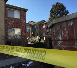 Sheriff's deputies remove a spotlight, Monday, Jan. 1, 2018, used to help investigators processing evidence at an apartment where Matthew Riehl fatally shot Douglas County Sheriff’s Deputy Zackari Parrish and wounded six others in the Denver suburb of Highlands Ranch, on Sunday.