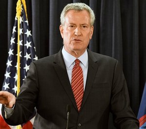 New York City Mayor Bill de Blasio speaks with reporters on Wednesday, Jan. 3, 2018, in Albany, N.Y.