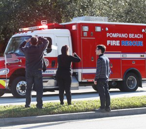 A shooting at Marjory Stoneman Douglas High School school sent students rushing into the streets as SWAT team members swarmed in and locked down the building. (Photo/ AP by Wilfredo Lee)