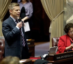 Sen. Jamie Pedersen, left, D-Seattle, speaks during debate on the Senate floor, Thursday, March 8, 2018, at the Capitol in Olympia, Wash., on the final day of the regular session of the Legislature. Lawmakers in the Senate were discussing a compromise measure designed to make it easier to prosecute police who commit reckless or negligent shootings in Washington state.