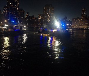 A pilot who survived when his helicopter went down in New York City's East River, killing five passengers, said in an emergency radio transmission that the aircraft's engine had failed. (Photo/AP)