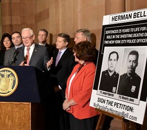 New York Sen. Martin Golden, R-Brooklyn, stands with legislators urging the parole board to reverse its decision to release inmate Herman Bell who was convicted in the 1971 murder of two New York City police officers during a news conference at the state Capitol Thursday, March 29, 2018, in Albany, N.Y. (AP Photo/Hans Pennink)