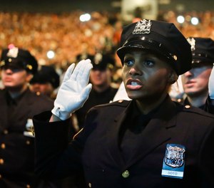 Members of New York Police Academy's July 2018 graduating class of 726 new NYPD police officers, pledge the Oath of Office during graduation ceremony, Monday July 2, 2018, in New York.