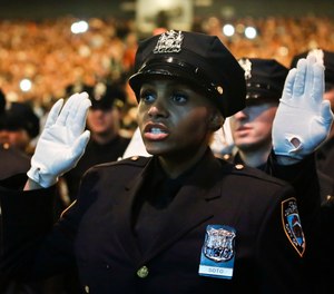 Members of New York Police Academy's July 2018 graduating class of 726 new NYPD police officers, pledge the Oath of Office during graduation ceremony, Monday July 2, 2018, in New York.