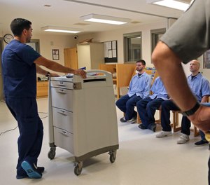 In this July 23, 2018, photo, several Franklin County Jail inmates are watched after receiving their daily dose of buprenorphine, a drug that controls heroin and opioid cravings.