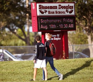 Student walk to class at Marjory Stoneman Douglas High School, Wednesday, Aug. 15, 2018, in Parkland, Fla. Students at the school returned Wednesday, to a more secure campus as they began their first new school year since a gunman killed 17 people in the freshman building.