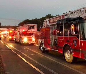 Multiple fire trucks from surrounding communities arrive Thursday, Sept. 13, 2018, in Lawrence, Mass., responding to a series of gas explosions and fires triggered by a problem with a gas line that feeds homes in several communities north of Boston.
