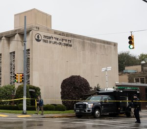 Police stand guard outside the Tree of Life Synagogue in Pittsburgh where a shooter opened fire Saturday, Oct. 27, 2018.