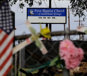 Memorials and messages hang on a fence at the First Baptist Church of Sutherland Springs, Wednesday, Oct. 31, 2018, in Sutherland Springs, Texas, one year since a gunman opened fire on worshippers attending Sunday service at the church, killing more than two dozen people and wounding others.