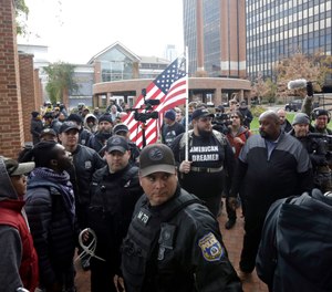 Activist who gave his name as Jersey walks with others under police escort after a
