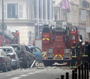 Firefighters work at the scene of a gas leak explosion in Paris, France, Saturday, Jan. 12, 2019. Paris police say several people have been injured in an explosion and fire at a bakery believed caused by a gas leak.