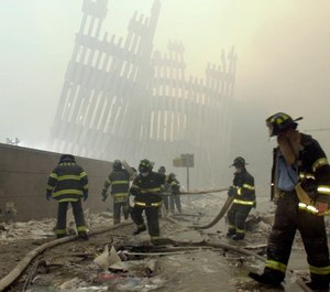 New York City firefighters work amid debris on Cortlandt St. after the terrorist attacks. (Photo/AP by Mark Lennihan)