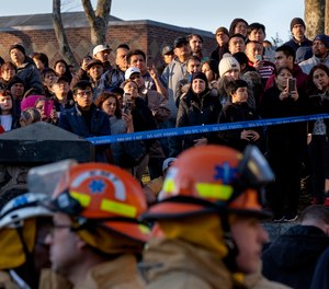 People watch as FDNY firefighters battle a multi-alarm fire in Brooklyn.