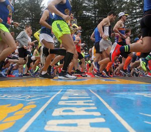 Runners cross the start line of the 123rd Boston Marathon on Monday, April 15, 2019, in Hopkinton, Mass.