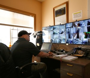 California Correctional Officer Alejandro Martinez monitors surveillance cameras at the Male Community Re-entry Program an alternative custody unit in Oroville, Calif.