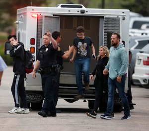 Students exit an ambulance at a recreation center for students to get reunited with their parents after a shooting at a suburban Denver middle school Tuesday, May 7, 2019, in Highlands Ranch, Colo. (AP Photo/David Zalubowski)