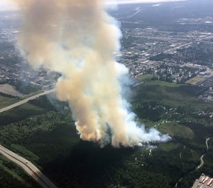 In this photo provided by the Alaska Division of Forestry, smoke rises from a wildfire in east Anchorage, Alaska. (Photo/Jason Jordet,Alaska Division of Forestry via AP)