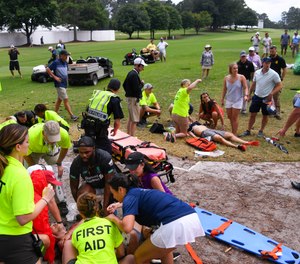 Spectators are tended to after a lightning strike on the East Lake Golf Club course left several injured during a weather delay in the third round of the Tour Championship golf tournament.