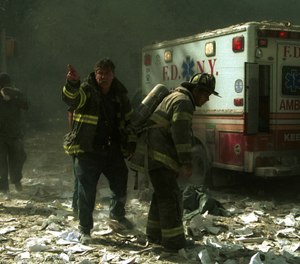 Firefighters at World Trade Center after the first building was struck. (Photo/AP, 1207223Globe, MediaPunch, IPX)