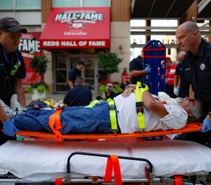 Emergency medical personnel load a simulated victim on a gurney during a mass casualty training exercise, Thursday, Sept. 19, 2019, in Cincinnati.
