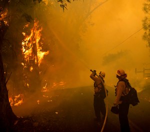 Firefighters battle a wildfire called the Kincade Fire on Chalk Hill Road in Healdsburg, Calif., Sunday, Oct. 27, 2019. (AP Photo/Noah Berger)