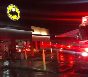 Emergency crews at the Buffalo Wild Wings restaurant in Burlington, Mass. Thursday night, Nov. 7, 2019. Massachusetts authorities say an employee of the restaurant has died and eight others have been hospitalized following a chemical mixture at the restaurant. WHDH-TV reports officials responded Thursday night to reports of a chemical reaction in the kitchen area of the Burlington restaurant where they found a male employee suffering from nausea. (Photo/John Guilfoil via AP)