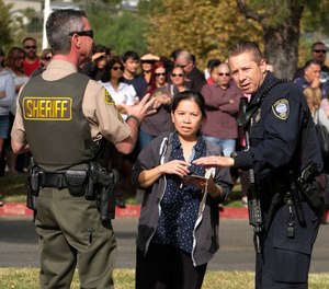 Parents wait to reunite with their children after a shooting at Saugus High School in Santa Clarita, Calif., Thursday, Nov. 14, 2019.