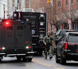 Police officers work nearby the scene of the JC Kosher Supermarket attack, Tuesday, Dec. 10, 2019, in Jersey City, N.J.