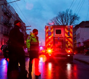 First responders and law enforcement personnel stand near the scene following a shooting, Tuesday, Dec. 10, 2019, in Jersey City, N.J.