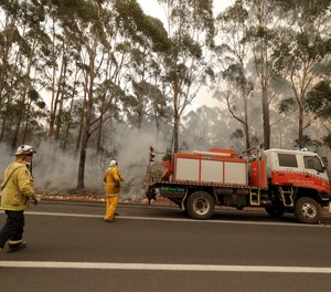 A firefighting crew battles a fire near Burrill Lake, Australia.