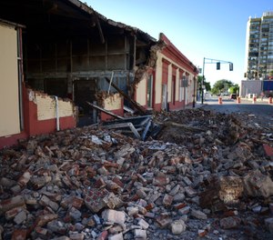 Debris from a collapsed wall of a building litters the ground after an earthquake struck Puerto Rico before dawn, in Ponce, Puerto Rico, Tuesday, Jan. 7, 2020.