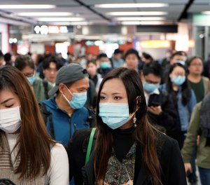 Passengers wear masks to prevent an outbreak of a new coronavirus in a subway station, in Hong Kong, Wednesday, Jan. 22, 2020.
