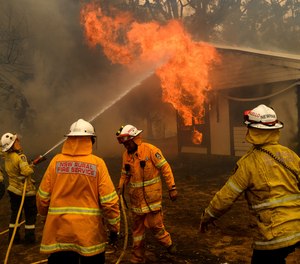Firefighters battle the Morton Fire as it burns a home near Bundanoon, New South Wales, Australia, on Thursday, Jan. 23, 2020.